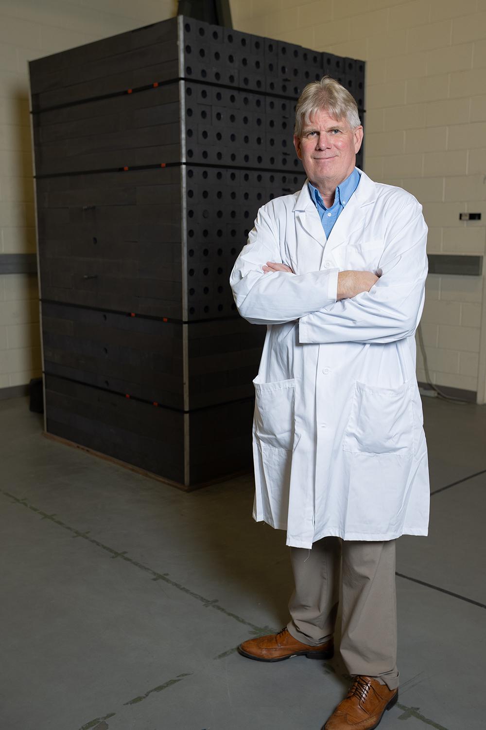 Steve Biegalski stands in front of a graphite pile