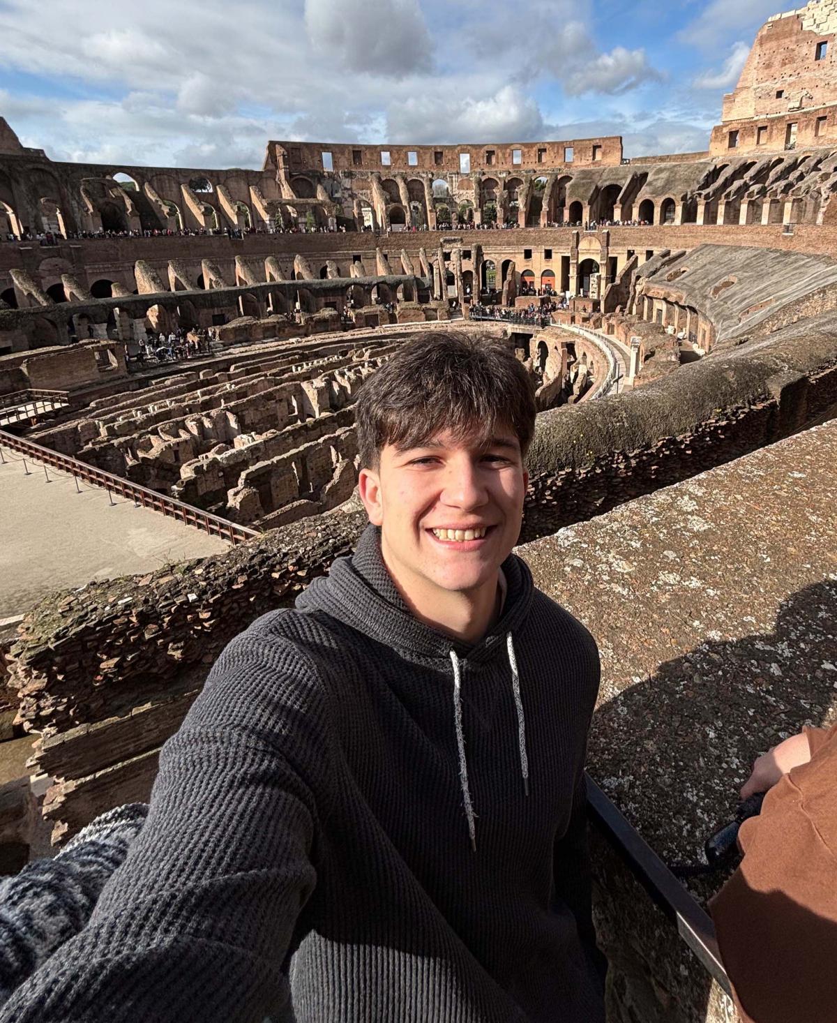 man standing inside the Colosseum in Rome