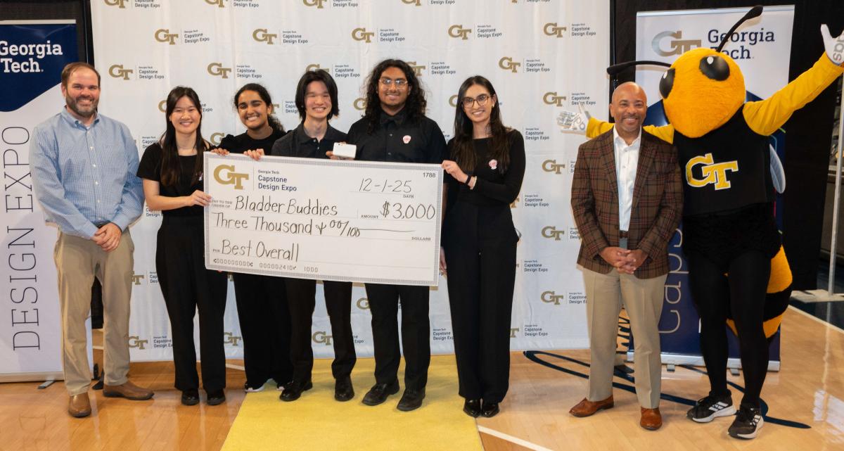 group of people with oversized check worth $3,000. recipients are Bladder Buddies team