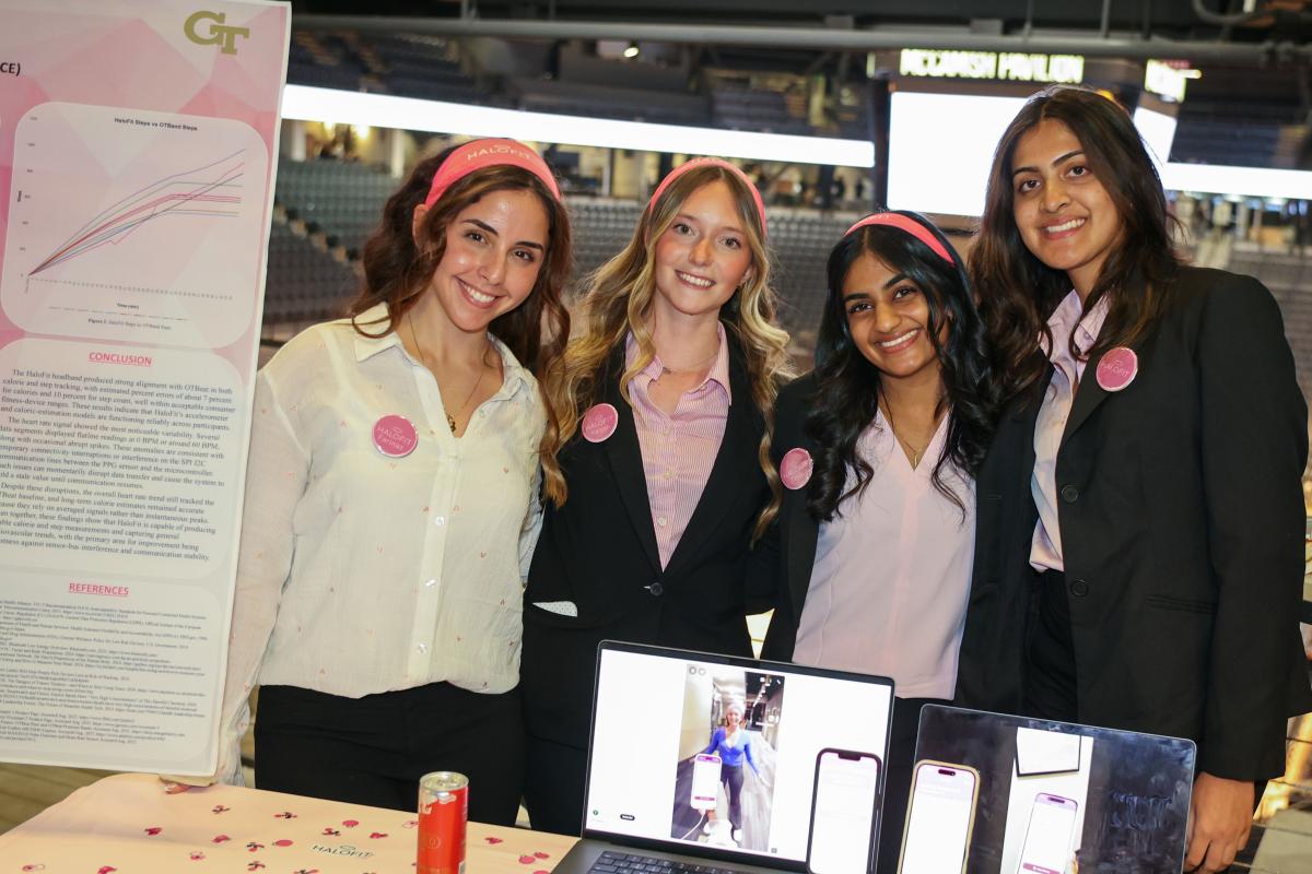 four women standing behind a table