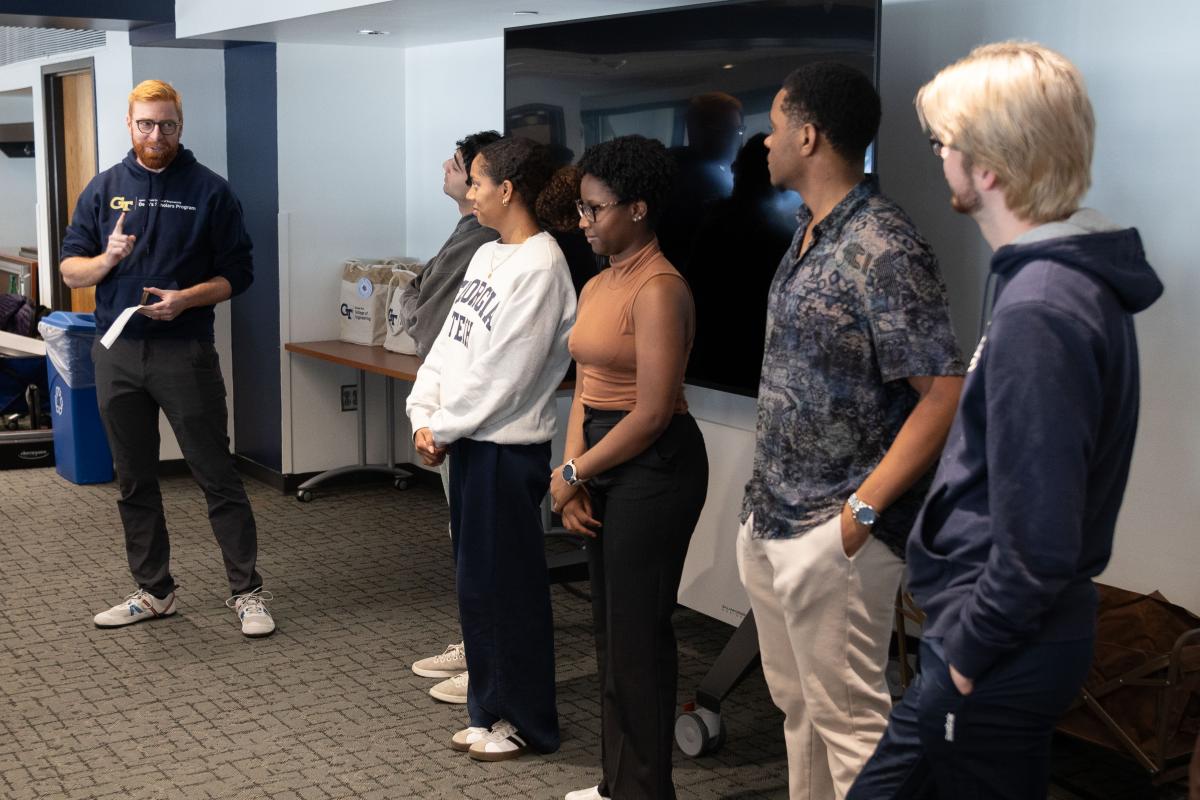 man talking with students