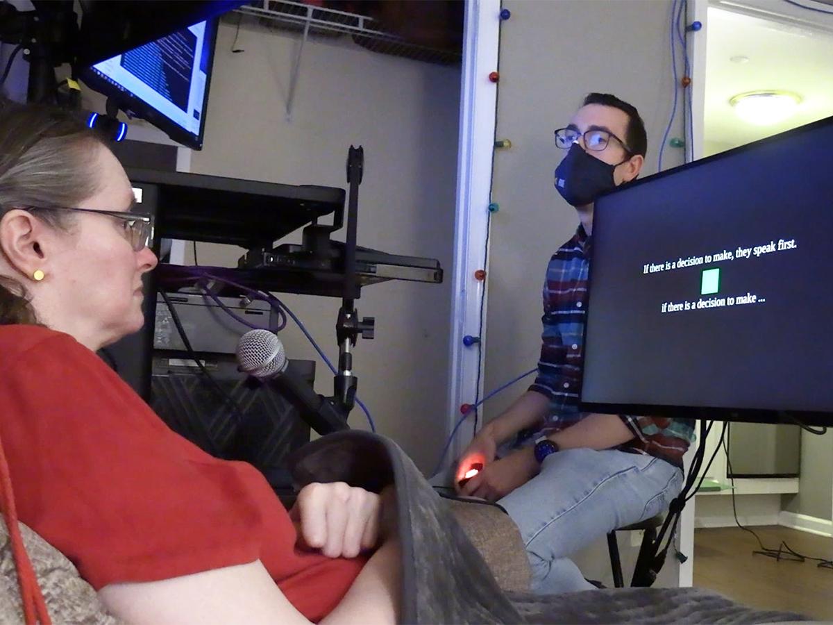 During a research session, a participant looks at a monitor and imagines saying the text cue displayed on screen. Text below the cue shows the brain-computer interface’s prediction of her imagined words.