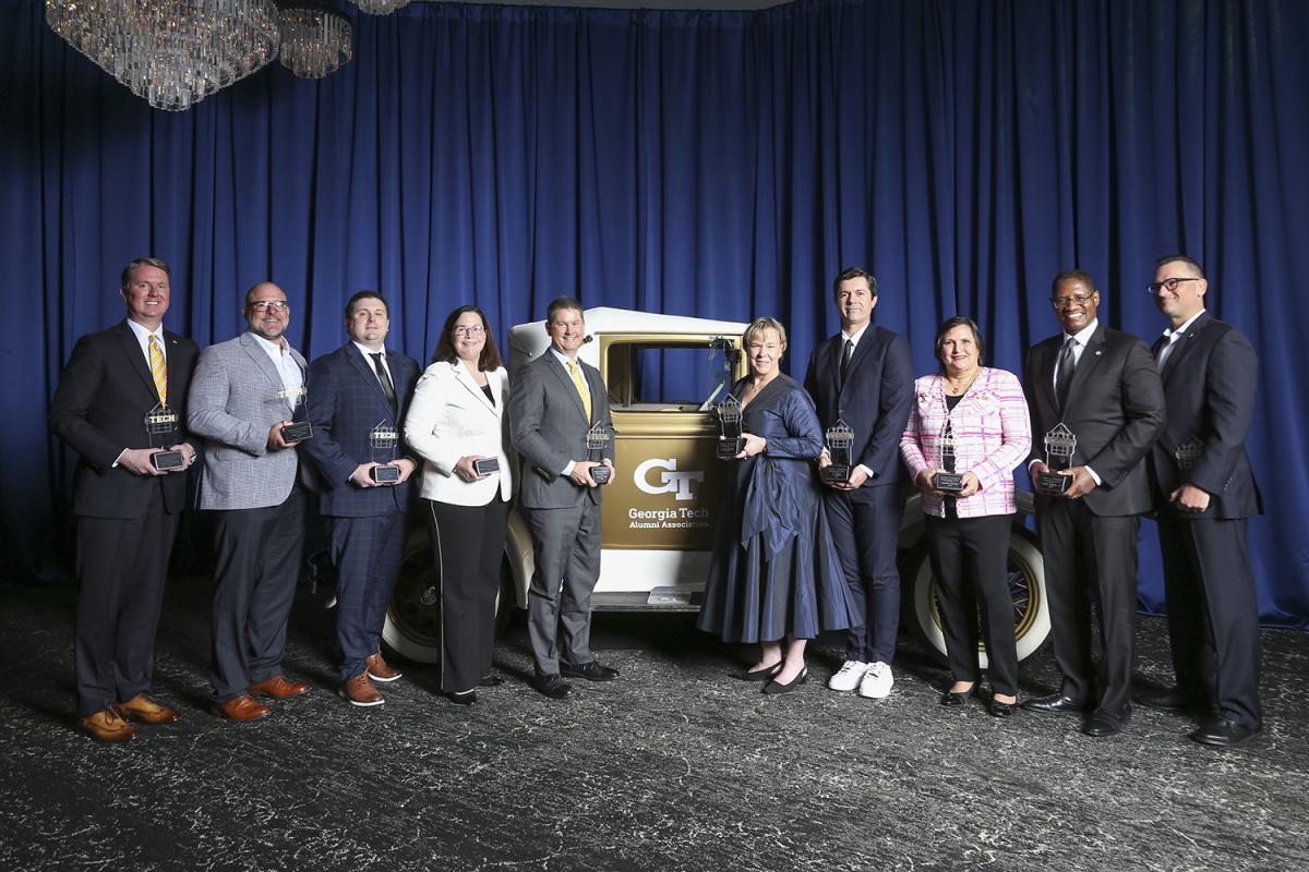 2026 Academy of Distinguished Engineering Alumni honorees pose with the Ramblin' Wreck.