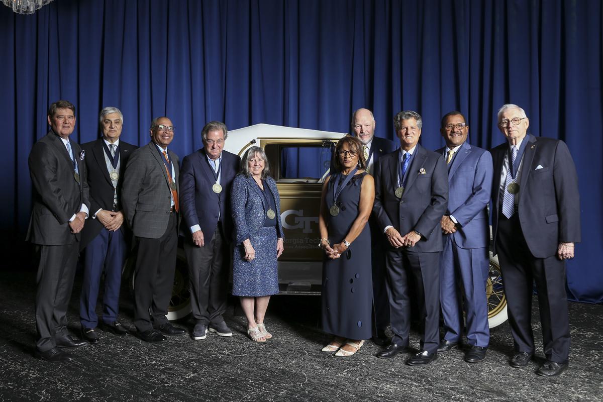 Newly inducted Engineering Hall of Fame members pose with the Ramblin' Wreck.