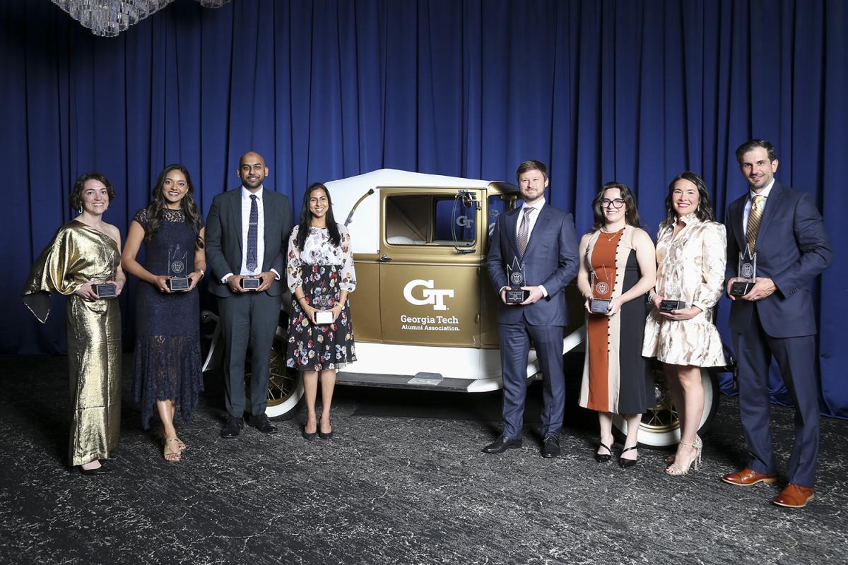 New members of the Council of Young Engineering Alumni pose with the Ramblin' Wreck.