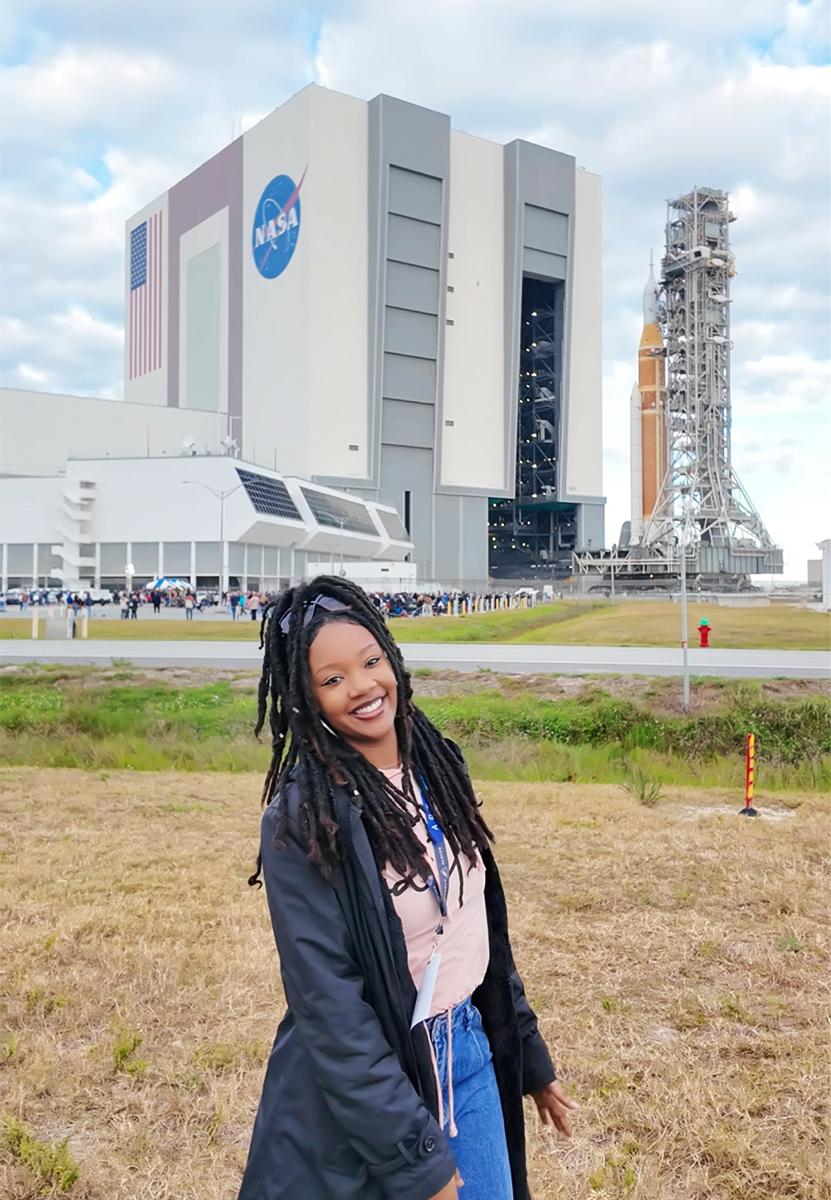 Naia Butler-Craig at Kennedy Space Center with the Vehicle Assembly Building in the background