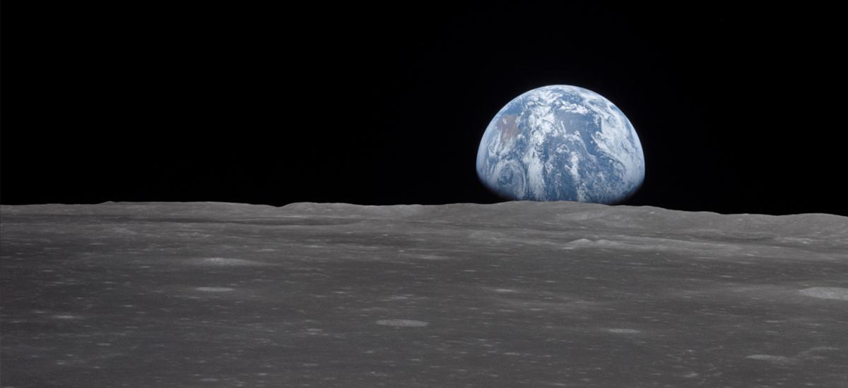 The Earth rising over the Moon's horizon
