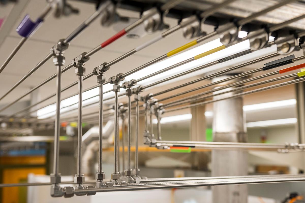 a closeup of rows of steel tubing with different color markers