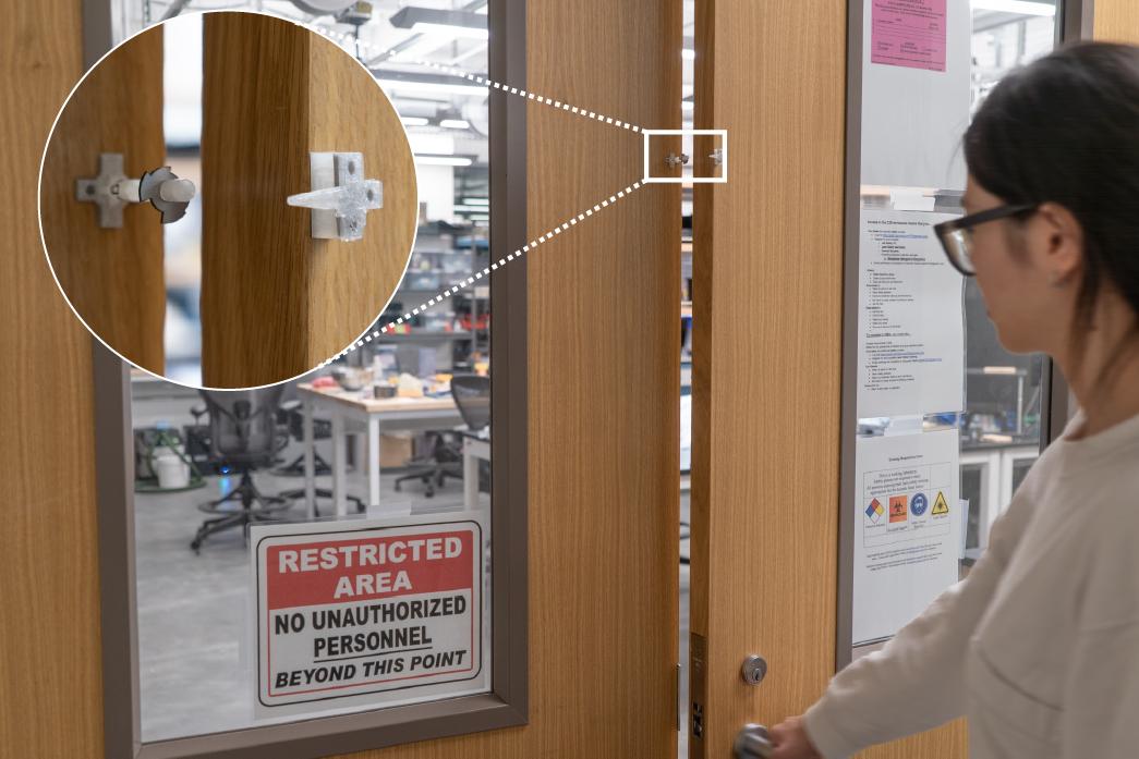 A person opening a lab door. An inset shows a prototype metal ultrasonic tag attached to the doorframe that is activated upon opening.