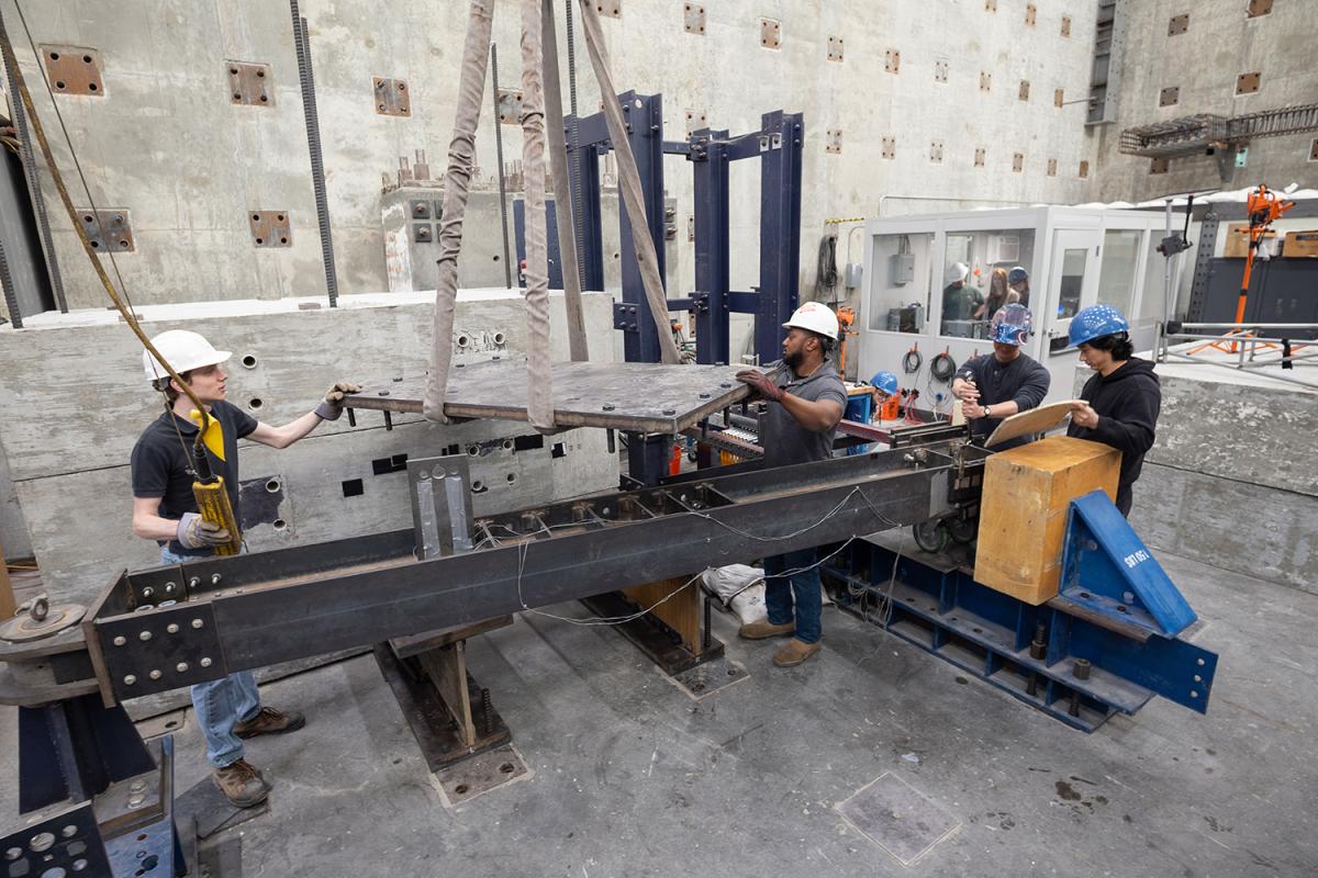 people moving a concrete slab in a lab