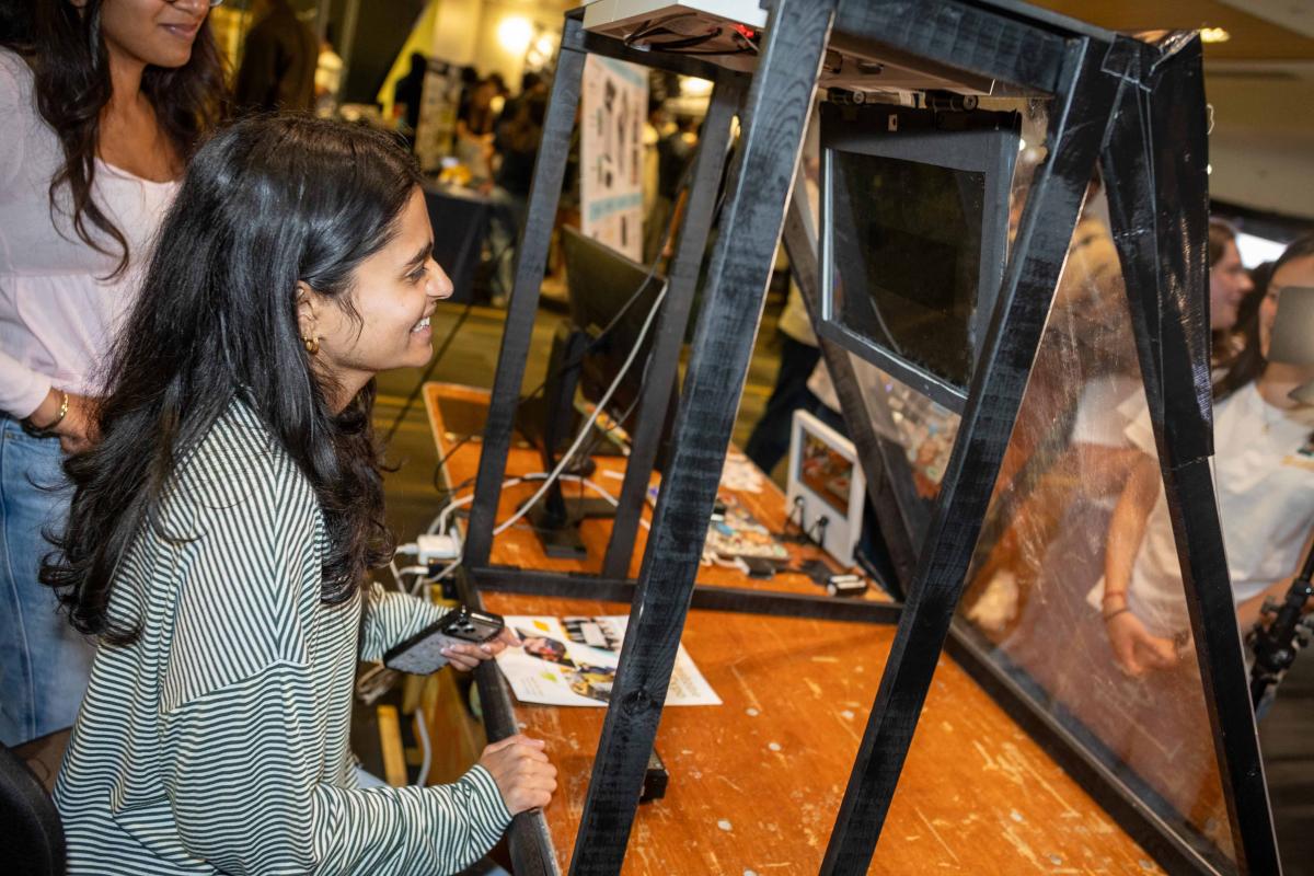 a women looking at a screen and makeshift windshield