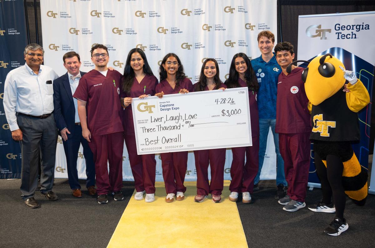 group of people holding oversized check