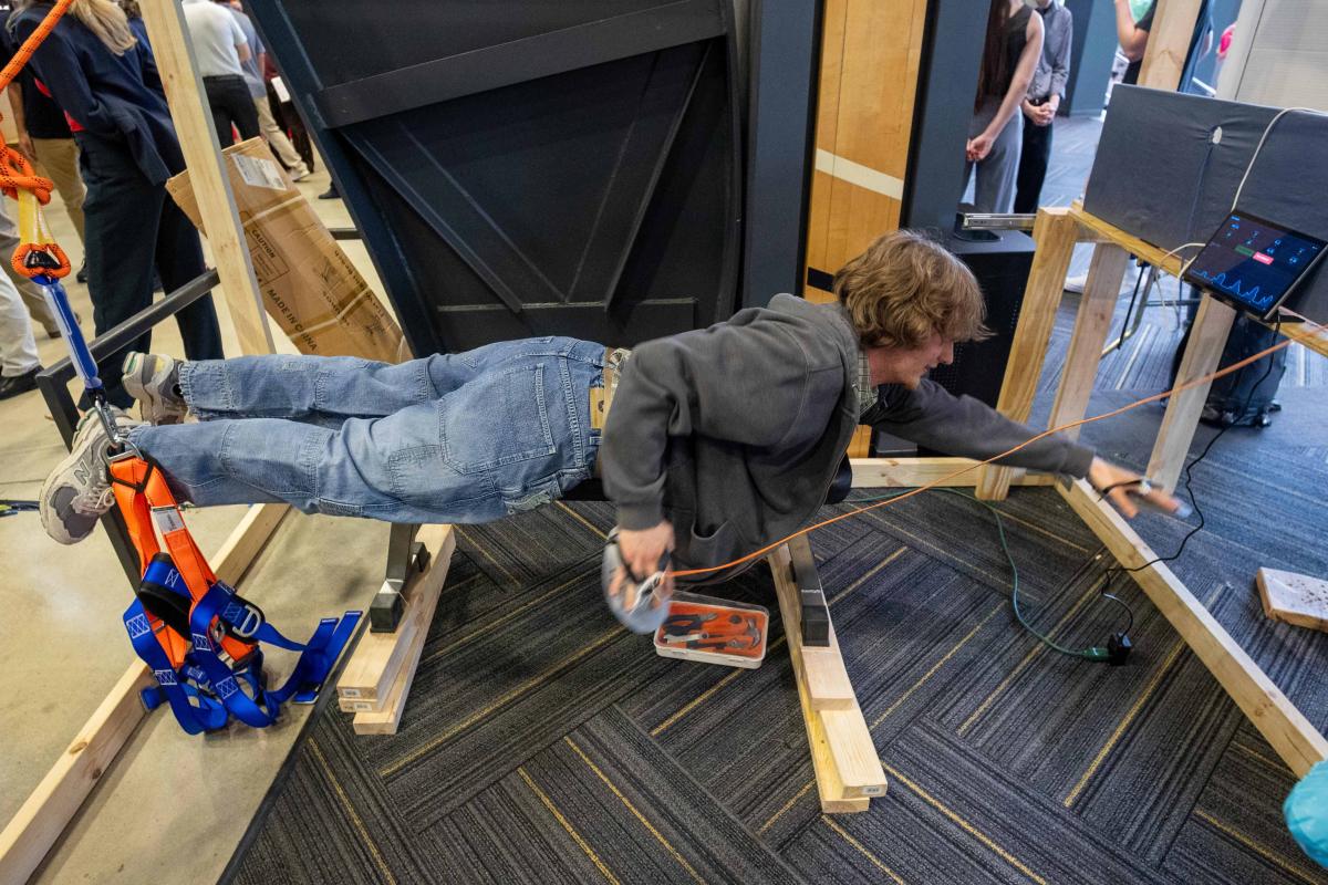 person laying down with outstretched arms in swimming motion