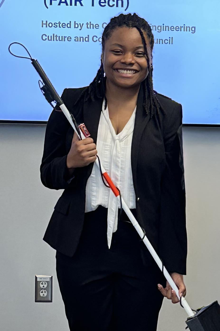 Janiya Richardson holds her prototype navigation system for visually impaired people.