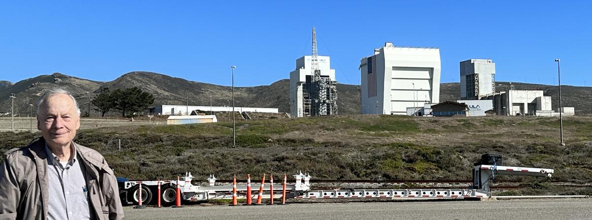 Ken Grundbord poses in 2023 in front of the launch facilities he helped build at Vandenberg Space Force Base.
