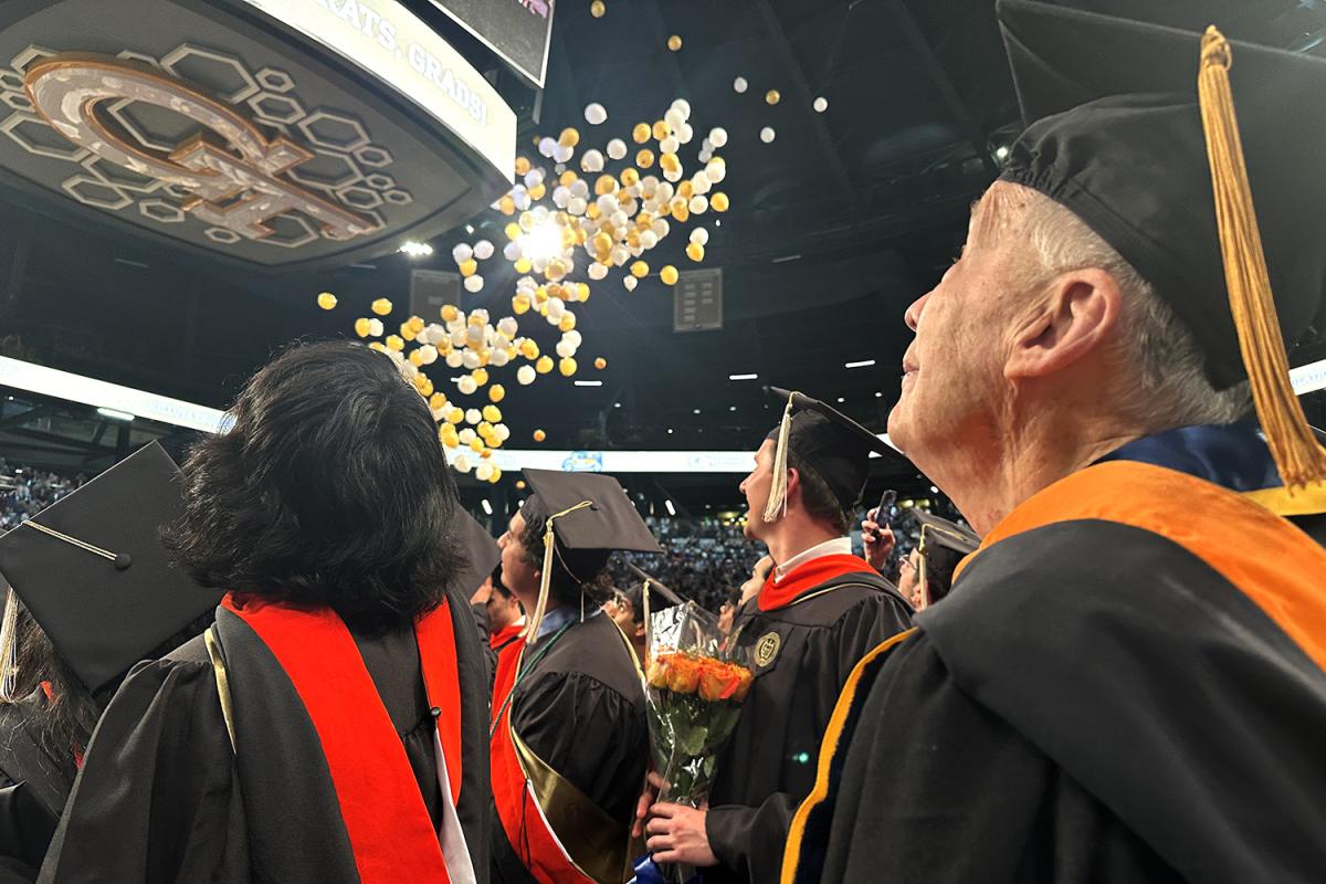 Kenneth Grundborg watches as balloons fall at the end of the Engineering Master's Graduation Celebration.