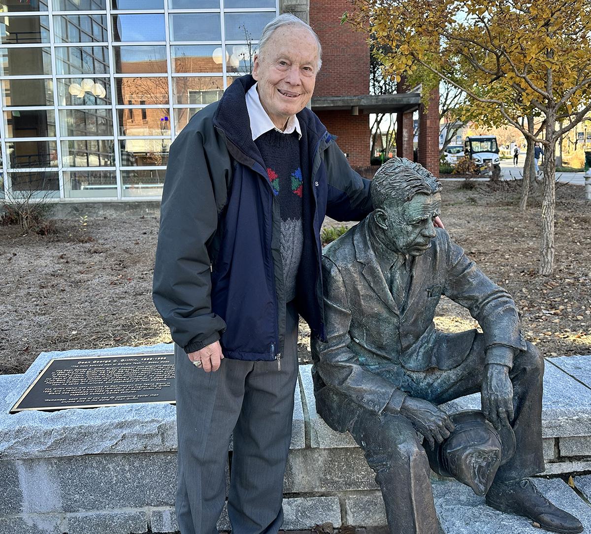 Ken Grundbord poses with the statue of Dean George Griffin on Georgia Tech's campus.