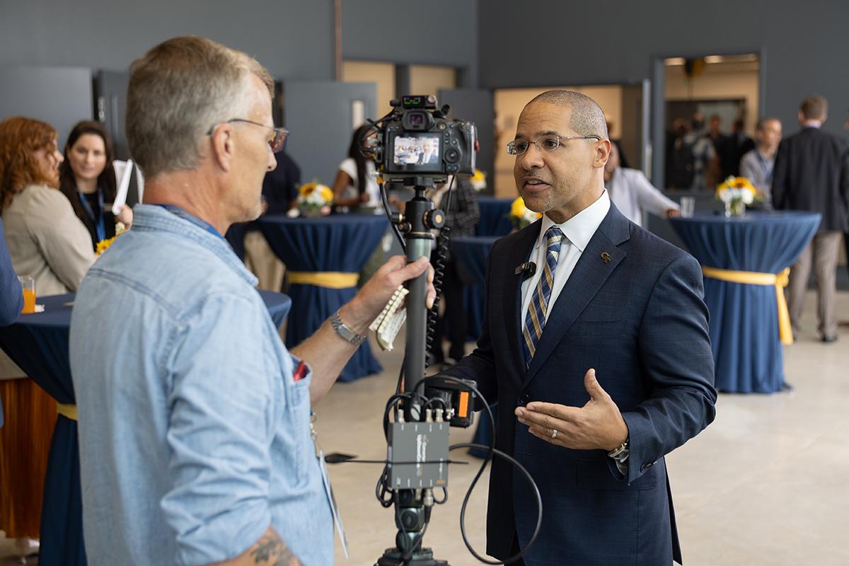 A person speaking into a video camera