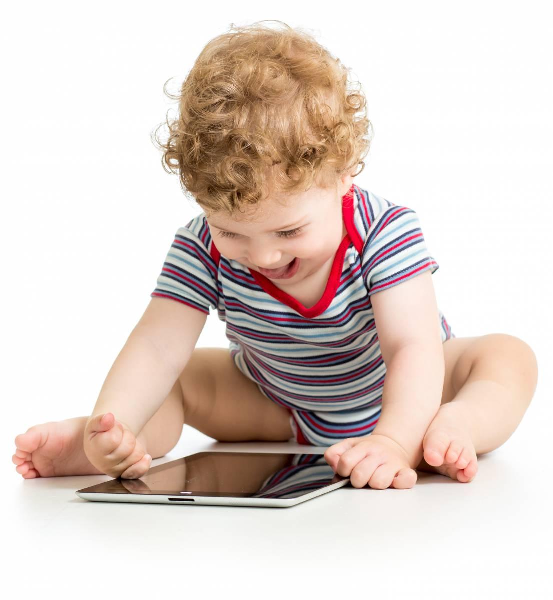 Toddler interacting with a tablet device