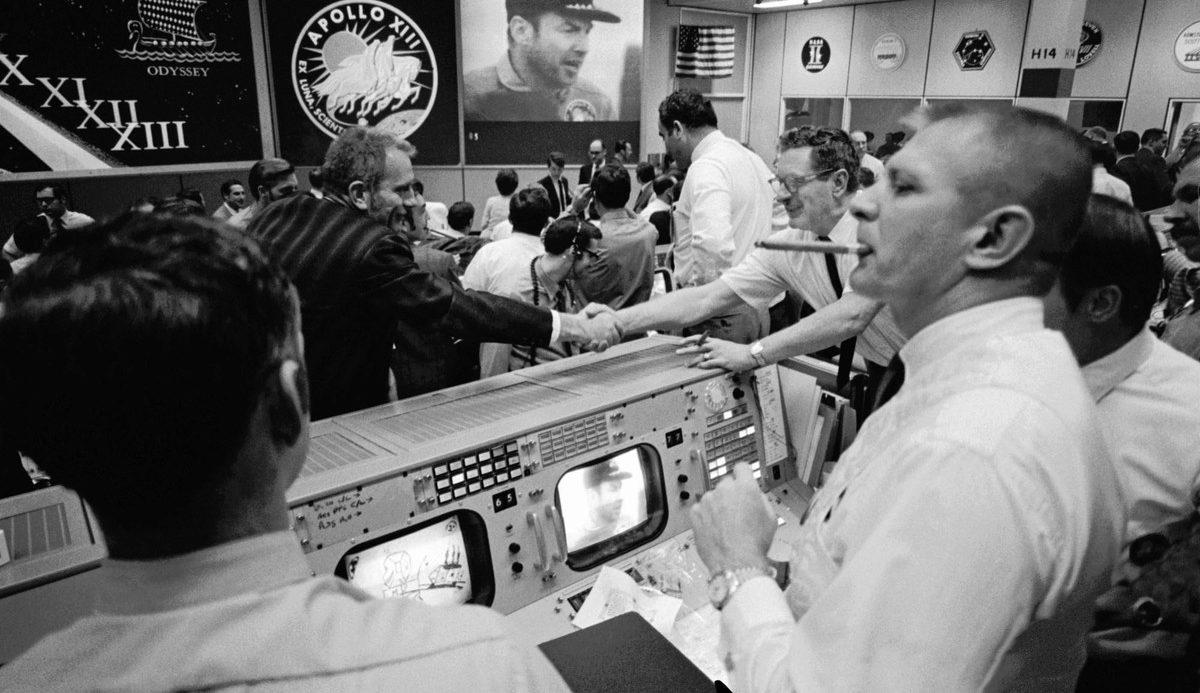 Flight Director Gene Franz and the rest of the team at mission control celebrate the crew's safe return home. 