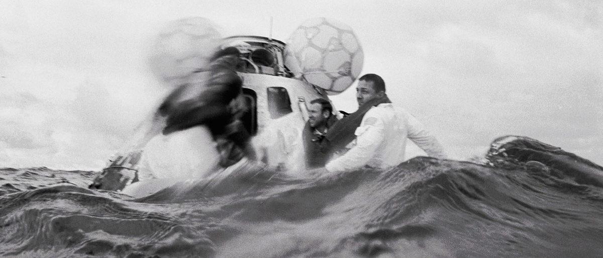 The crew wait for the rescue helicopter after splashdown