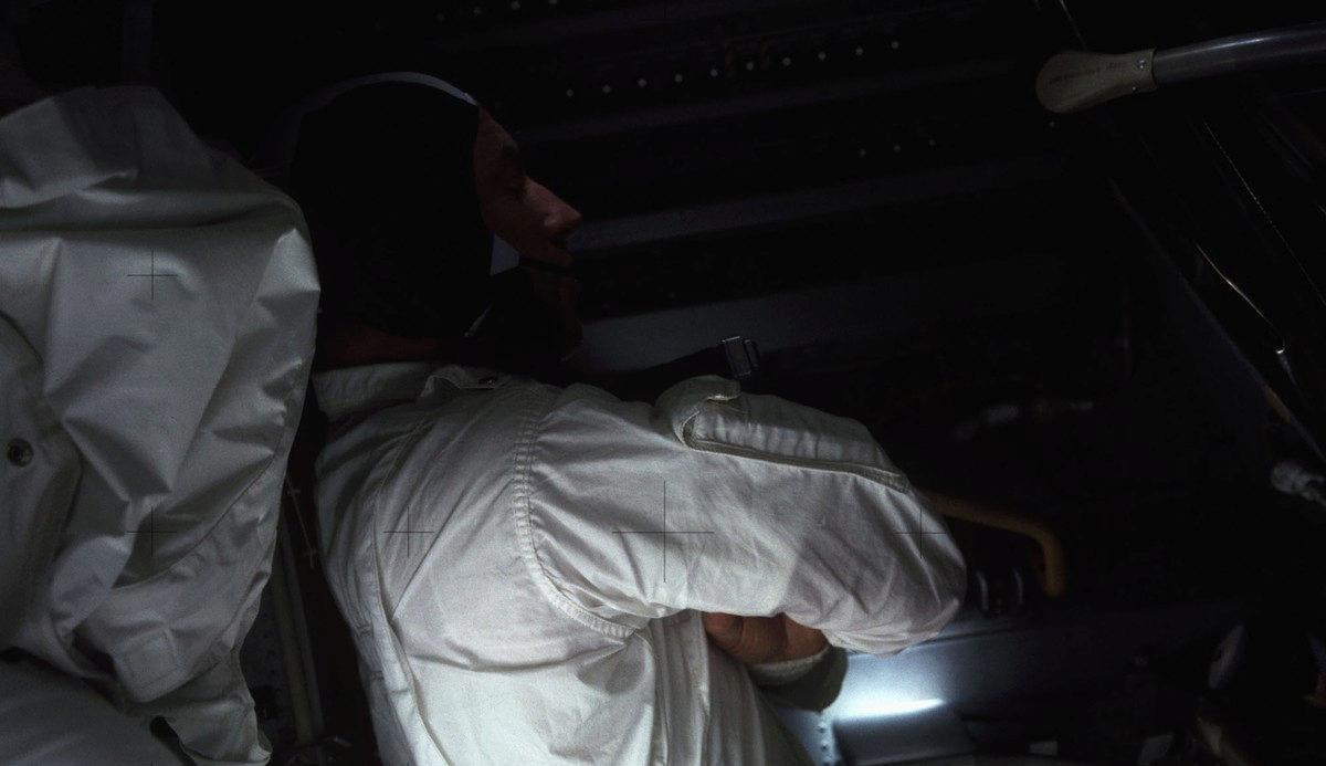 One of the Apollo 13 astronauts trying to sleep in the cold, dark spacecraft after power down.