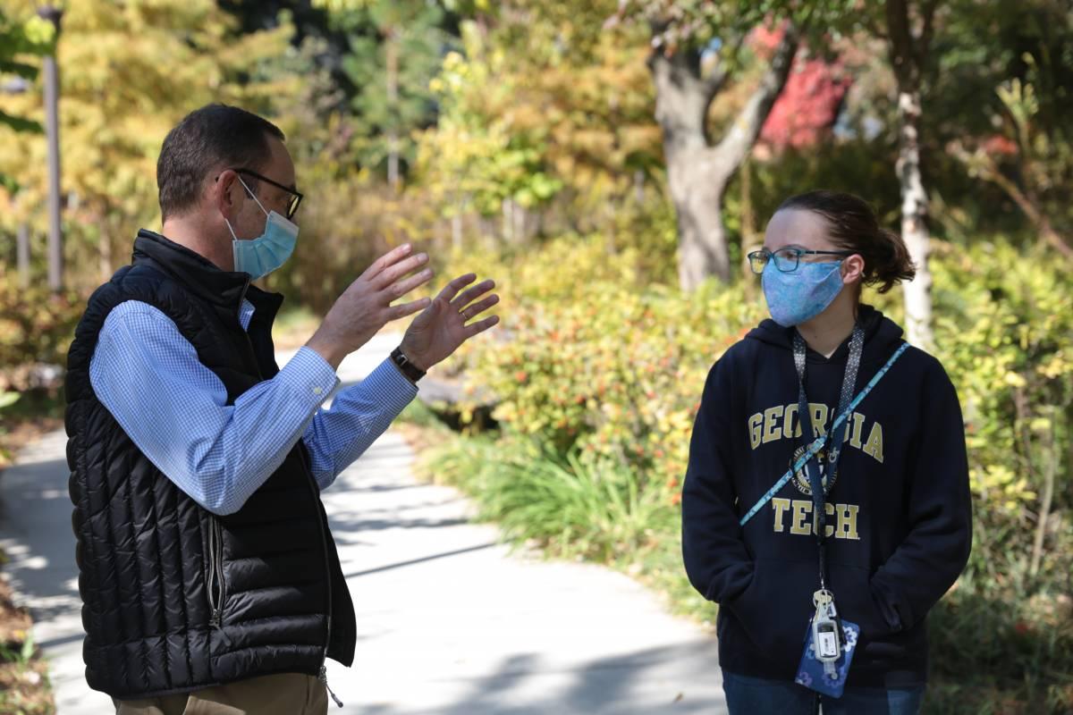 prof and student outside in masks 