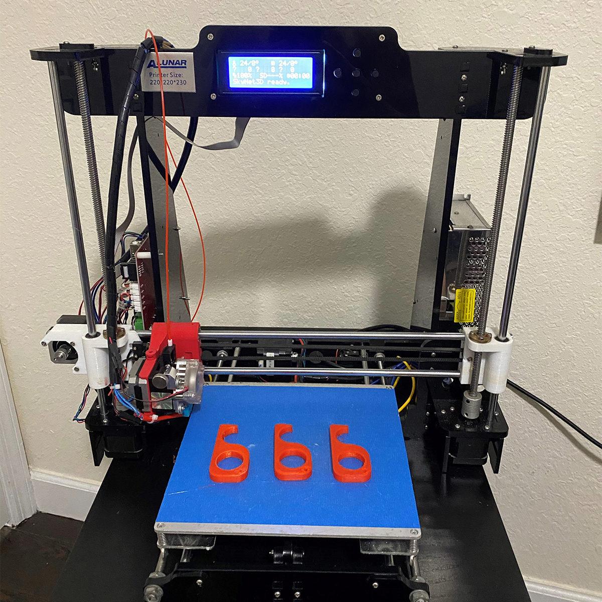 3D printer and no-touch door openers on display. 