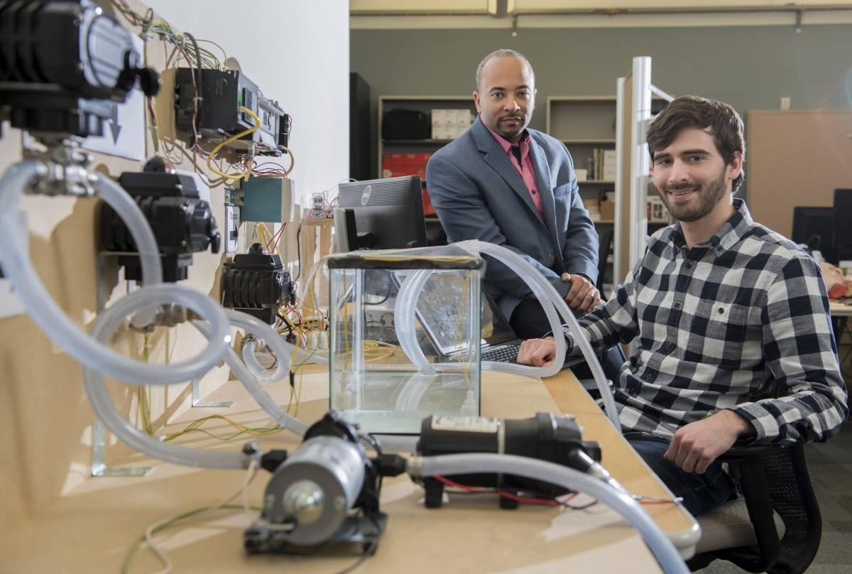 Beyah and David Formby with a water treatment plant testbed in the lab.