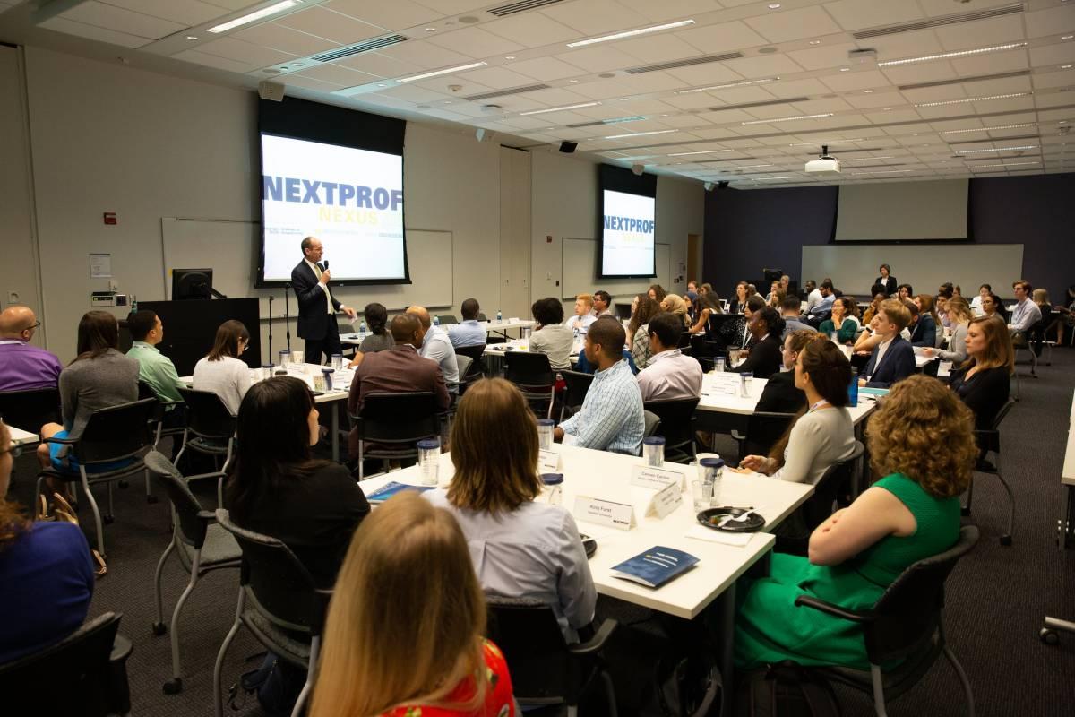 2019 NextProf event-people raising hands
