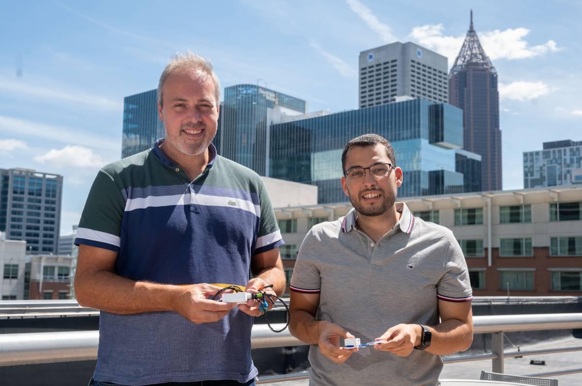 Samer Mabrouk and Omer Inan hold prototypes of their device