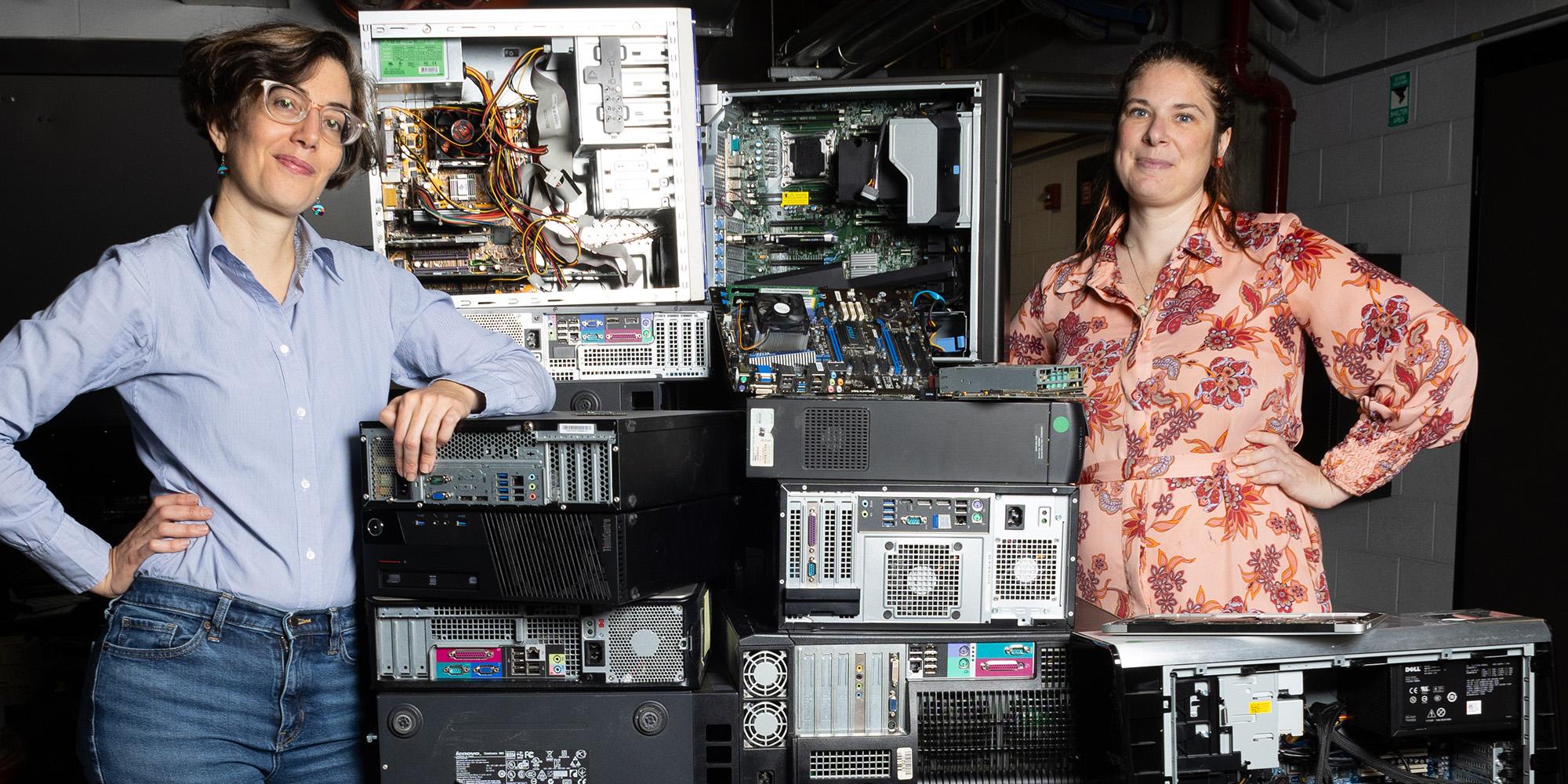 Two women professors standing next to old computer equipment. Text overlay: The race against waste. In the quest to reduce, reuse, and recycle, Georgia Tech engineers are at work on ways to divert more trash from landfills, tame plastic pollution, and cut waste from electronics. 