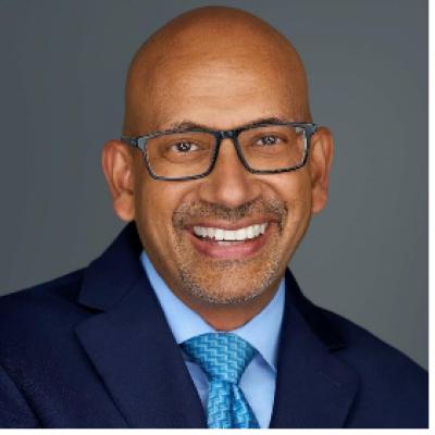 Narayanan Krishnakumar in tie and coat, looking at camera