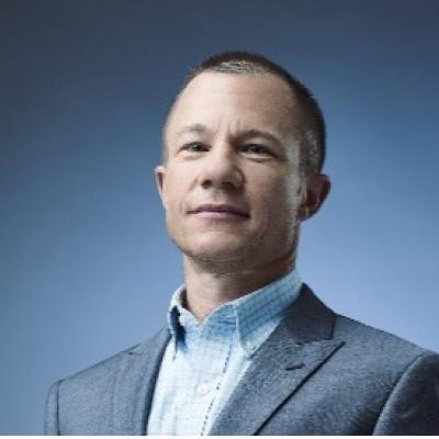 Todd Whitmore in front of blue background